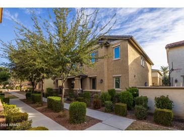 Tan two-story home with landscaping and walkway at 924 S Osborn Ln, Gilbert, AZ 85296