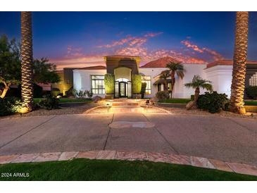 Luxury home entrance with palm trees and landscape lighting at dusk at 5112 E Pasadena Ave, Phoenix, AZ 85018