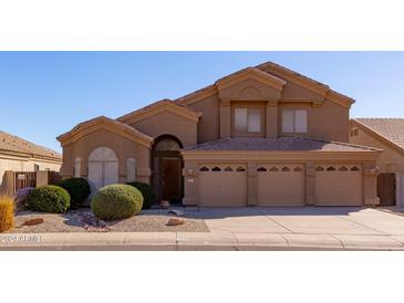 Two-story house with a three-car garage and manicured landscaping at 16847 S 13Th Way, Phoenix, AZ 85048
