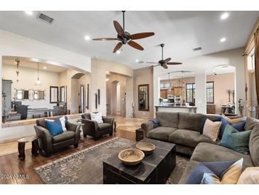 Spacious living room with hardwood floors, comfortable seating, and ceiling fans at 4243 E Ashler Hills Dr, Cave Creek, AZ 85331