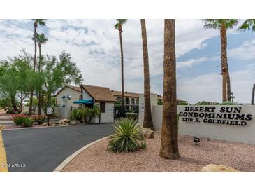 Desert Sun Condominiums entrance with palm trees and signage at 3270 S Goldfield Rd # 217, Apache Junction, AZ 85119