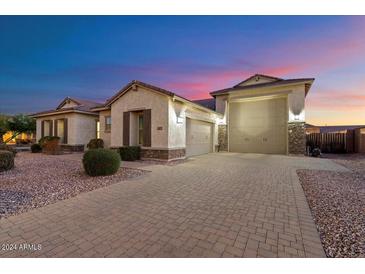 Two-story home with a large driveway and three-car garage at 18577 W Coolidge St, Goodyear, AZ 85395