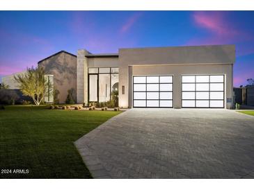 Modern house with two-car garage and landscaping at 6921 N Joshua Tree Ct, Paradise Valley, AZ 85253