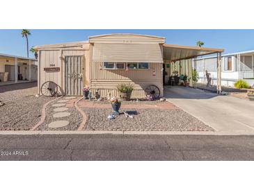 Mobile home with decorative landscaping and covered carport at 2650 W Union Hills Dr # 184, Phoenix, AZ 85027