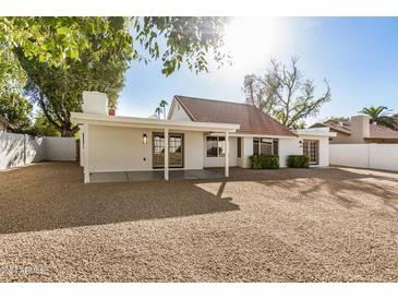 Backyard view of house, covered patio, and gravel at 5310 E Kathleen Rd, Scottsdale, AZ 85254