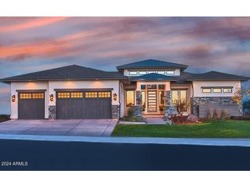 Stunning home with three-car garage and stone accents at 5516 W Melinda Ln, Glendale, AZ 85308