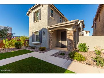 Two-story house with gray siding, stone accents, and a landscaped front yard at 2772 S Betty St, Gilbert, AZ 85295