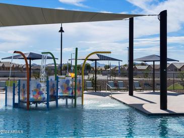 Relaxing community pool area with shade structures and water features at 3187 E Hayden Rose Ave, San Tan Valley, AZ 85143