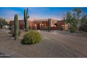 Beautiful desert landscape with a stucco home and brick driveway at 23461 N 80Th Way, Scottsdale, AZ 85255