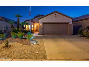 Charming single story home with landscaped front yard and two car garage at 15877 W Arrowhead Dr, Surprise, AZ 85374