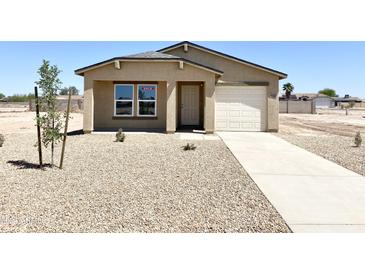 Newly built home with a single-car garage and desert landscaping at 8572 W Raven Dr, Arizona City, AZ 85123