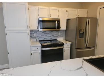 Kitchen with stainless steel appliances and white cabinets at 1942 S Emerson -- # 131, Mesa, AZ 85210