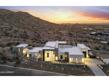 Stunning aerial view of a modern home nestled in the desert landscape at 9520 S Krista W Dr, Goodyear, AZ 85338