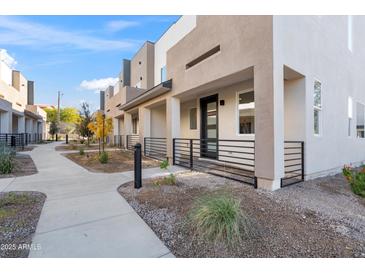 Modern two-story townhome with private patio and walkway at 2125 E Voltaire Ave, Phoenix, AZ 85022