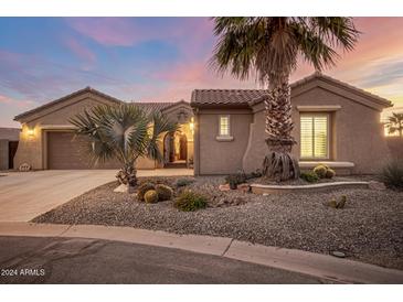 Tan two-story house with a three-car garage and desert landscaping at 4675 N Bryce Canyon Ct, Eloy, AZ 85131