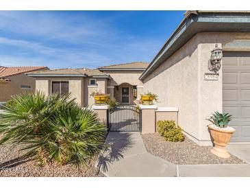 Front entry with walkway, gate, and desert landscaping at 26984 W Yukon Dr, Buckeye, AZ 85396