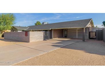 Single-story home with carport and modern brick facade at 3033 E Sierra St, Phoenix, AZ 85028