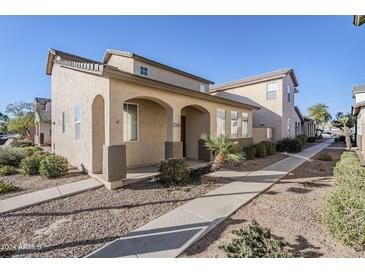 Two-story house with tan exterior, walkway, and landscaping at 5138 W Fulton St, Phoenix, AZ 85043