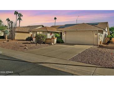 Single-story home with two-car garage and landscaped front yard at 18903 N 97Th Ln, Peoria, AZ 85382