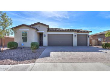 Single-story house with a three-car garage and landscaping at 1619 E Joelle Dr, Casa Grande, AZ 85122