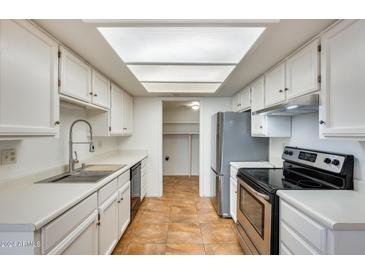Bright kitchen features stainless steel appliances and ample counter space at 222 W Brown Rd # 117, Mesa, AZ 85201