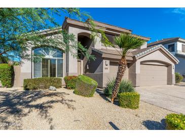 Two-story home with landscaped yard and two-car garage at 6406 E Carolina Dr, Scottsdale, AZ 85254