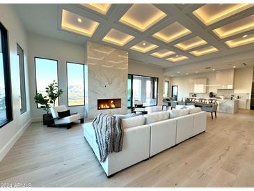 Spacious living room with a modern fireplace and stunning mountain views at 4880 E Lone Mountain N Rd, Cave Creek, AZ 85331