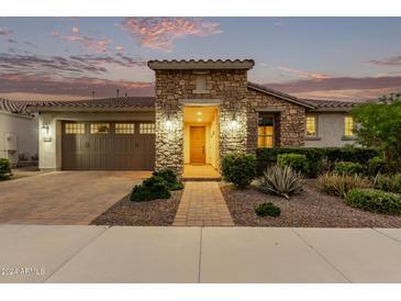 Charming stone elevation home with landscaped front yard at 10553 E Relativity Ave, Mesa, AZ 85212