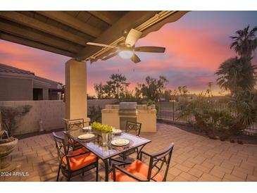 Outdoor patio with seating area, built-in grill, and sunset view at 6202 E Mckellips Rd # 141, Mesa, AZ 85215