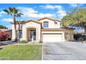 Two-story house with a large driveway and landscaping at 14462 W Avalon Dr, Goodyear, AZ 85395
