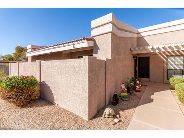 Inviting exterior of a condo with a walkway and landscaping at 3030 S Alma School Rd # 12, Mesa, AZ 85210
