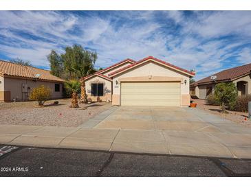 Single-story house with attached garage and desert landscaping at 13652 W Fargo Dr, Surprise, AZ 85374