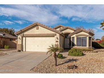 Single-story house with a two-car garage and desert landscaping at 3010 S Crawford Cir, Mesa, AZ 85212