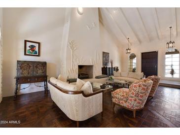 Elegant living room featuring a stunning fireplace and hardwood floors at 6701 N Scottsdale Rd # 20, Scottsdale, AZ 85250