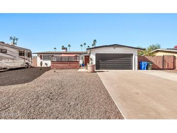 House exterior featuring a driveway, garage, and landscaping at 12414 N 33Rd St, Phoenix, AZ 85032