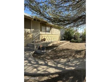 Ranch style home with a spacious front yard and mature tree at 411 N Scott Ave, Gila Bend, AZ 85337