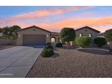 Single-story home with a two-car garage and desert landscaping at 5344 N Crestland Ct, Litchfield Park, AZ 85340