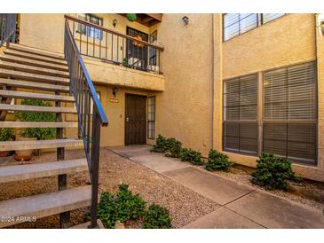 Exterior view of condo building with stairs and landscaping at 8201 N 21St Dr # C107, Phoenix, AZ 85021