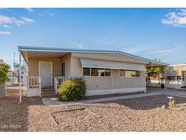 Single-wide manufactured home with carport and landscaped yard at 2650 W Union Hills Dr # 155, Phoenix, AZ 85027