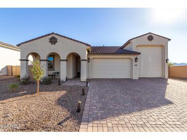 Two-story house with a three-car garage and landscaped front yard at 5203 W Roundhouse Rd, Laveen, AZ 85339