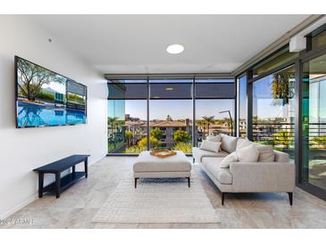Modern living room with city view, comfy sofa, and large TV at 7120 E Kierland Blvd # 416, Scottsdale, AZ 85254