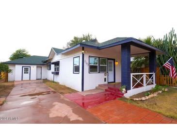 Charming bungalow with a red brick walkway and well-manicured lawn at 2143 W Wilshire Dr, Phoenix, AZ 85009