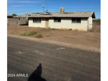 Ranch style home with a large front yard and mature landscaping at 390 W Poston Cir, Florence, AZ 85132