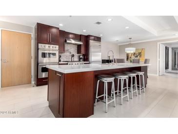 Modern kitchen featuring stainless steel appliances and an expansive island at 7137 E Rancho Vista Dr # 2002, Scottsdale, AZ 85251