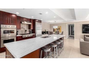 Modern kitchen with stainless steel appliances and an island at 7137 E Rancho Vista Dr # 2002, Scottsdale, AZ 85251