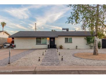 Single-story home with landscaped yard and walkway at 1739 E Pleasant Ln, Phoenix, AZ 85042