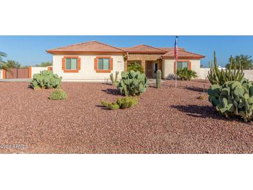 Single-story home with desert landscaping and a three-car garage at 30124 W Mckinley St, Buckeye, AZ 85396