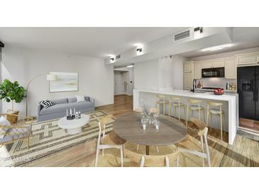 Open concept dining area with kitchen access and modern wood table at 4808 N 24Th St # 531, Phoenix, AZ 85016