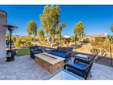 Backyard patio with fire pit and seating area at 20784 W Minnezona Ave, Buckeye, AZ 85396