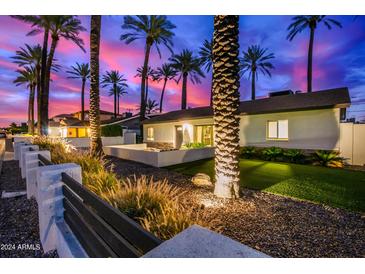 Stunning curb appeal at night; single-story home with palm trees and modern landscaping at 4311 E Roma Ave, Phoenix, AZ 85018
